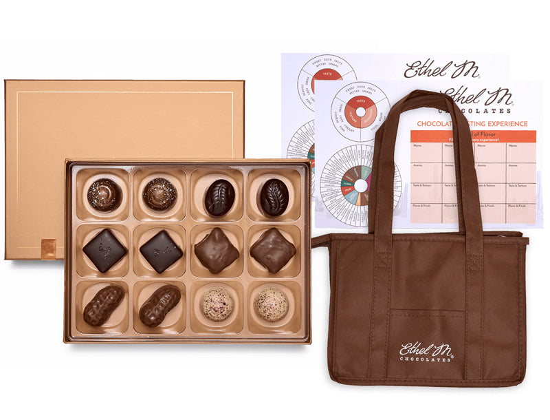 Ethel M Chocolates Chocolatier's Choice Private Online Tasting Kit. Image shows twelve pieces of chocolate in a copper-colored gift box, Tasting Mats, and Insulated Tote Bag.