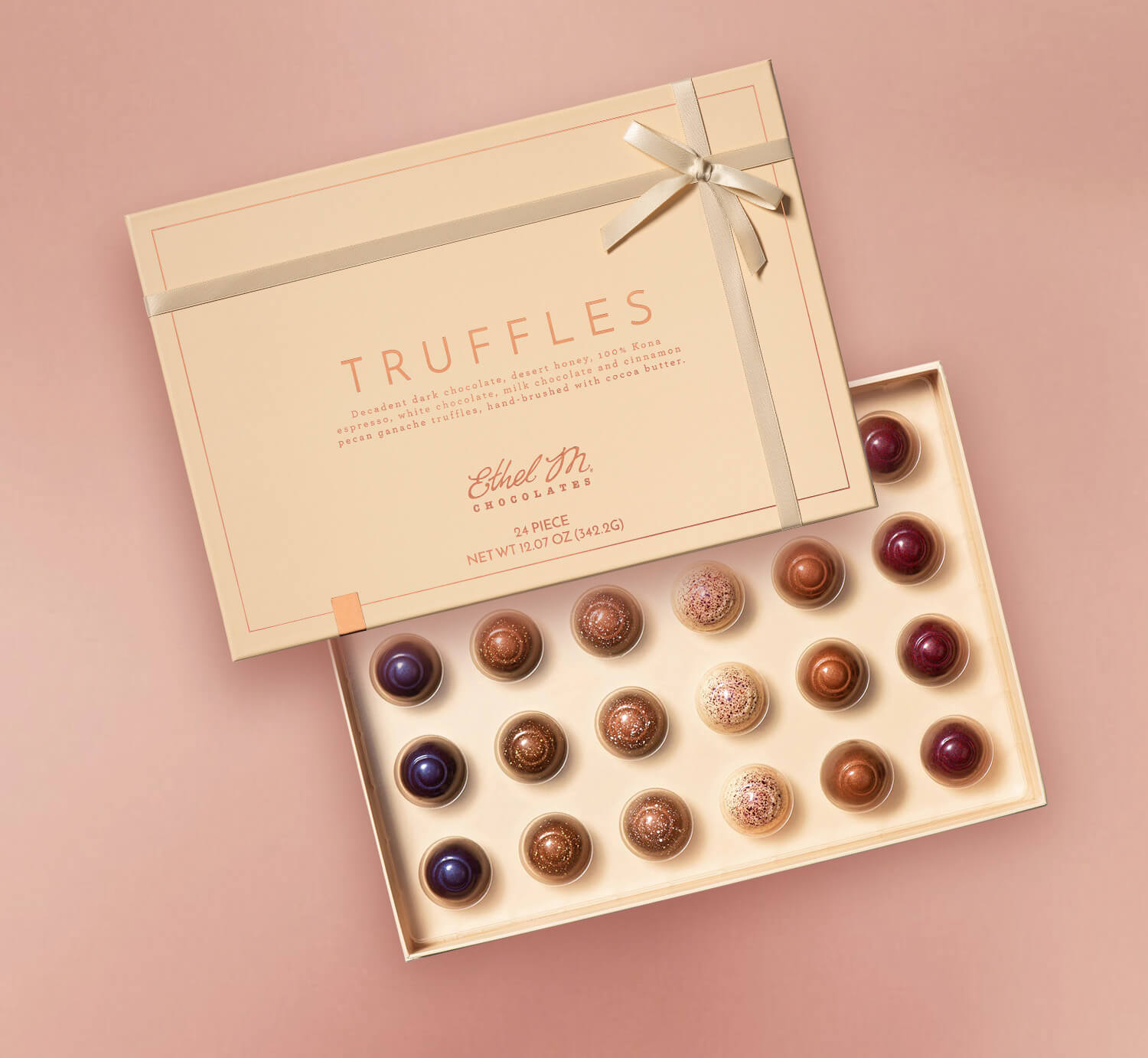 Ethel M Chocolates box of truffles on a pink background
